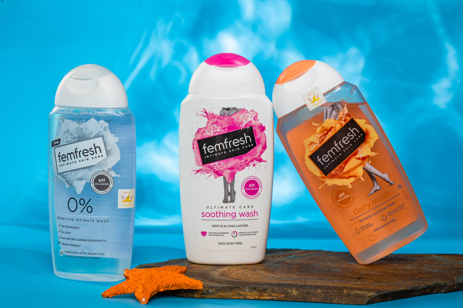 Bright and lively shot of three Femfresh bathing products against a blue watery background.