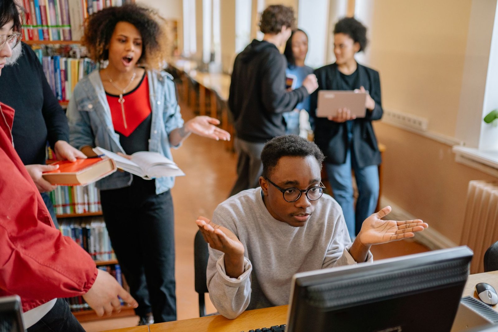 A group of students working together in a university library, engaging in a group study session.
