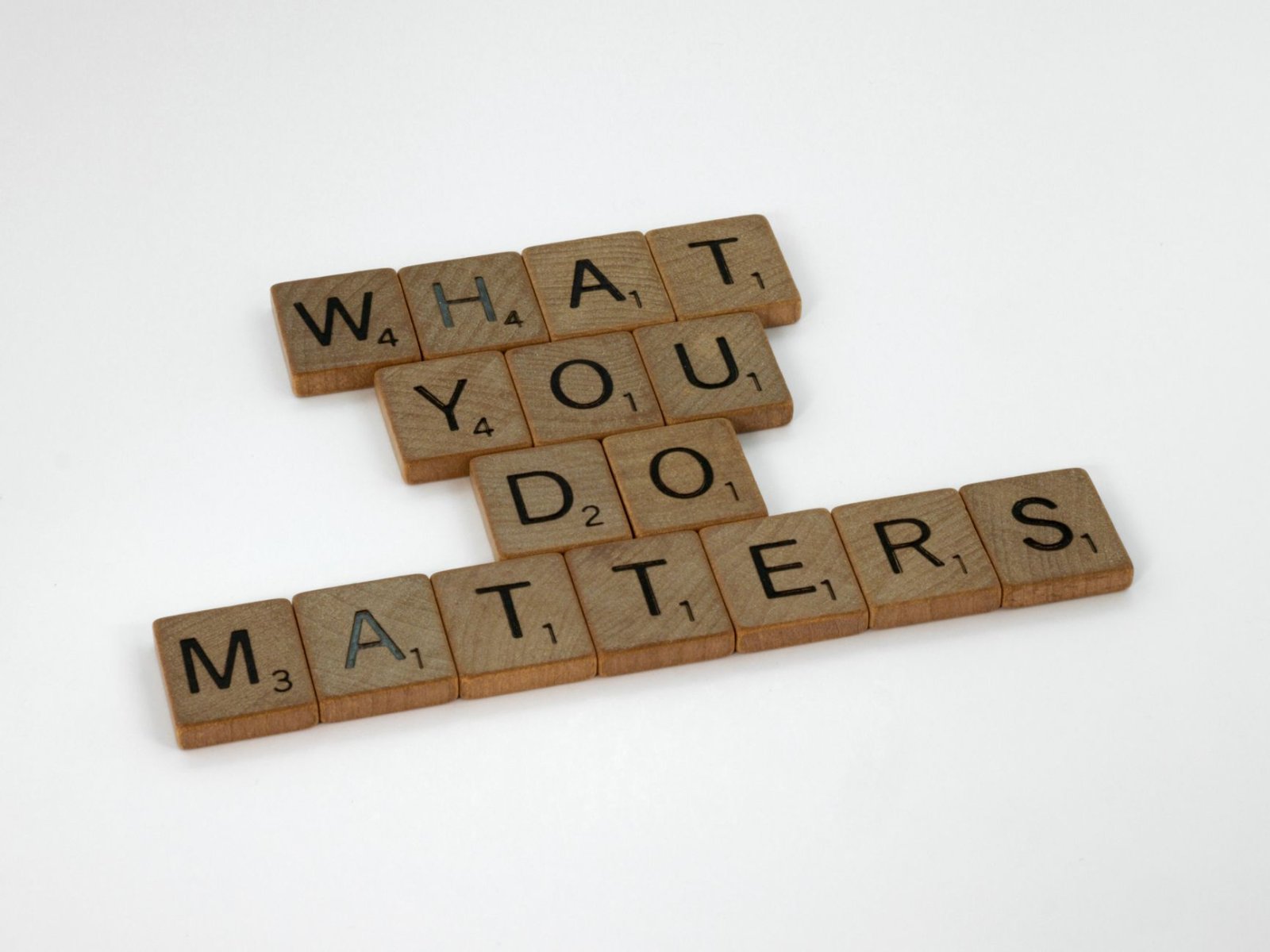 Wooden letter tiles spelling 'What You Do Matters' on a neutral background.