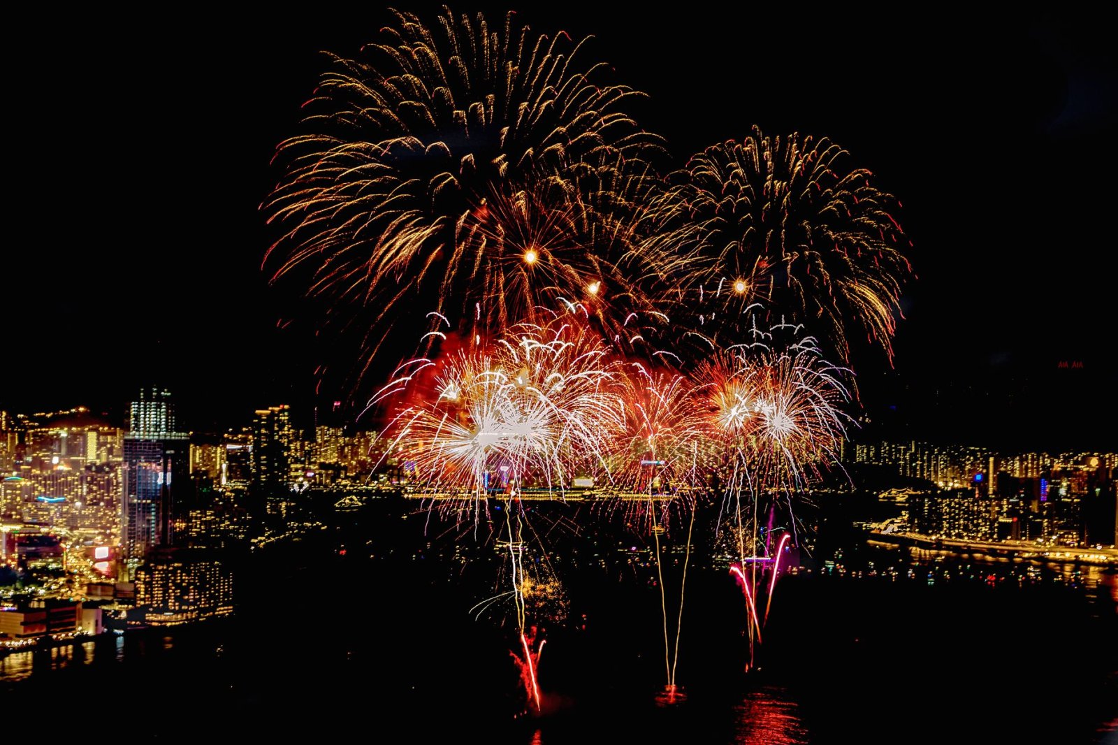 Spectacular fireworks illuminate the city skyline at night, creating a breathtaking visual spectacle.